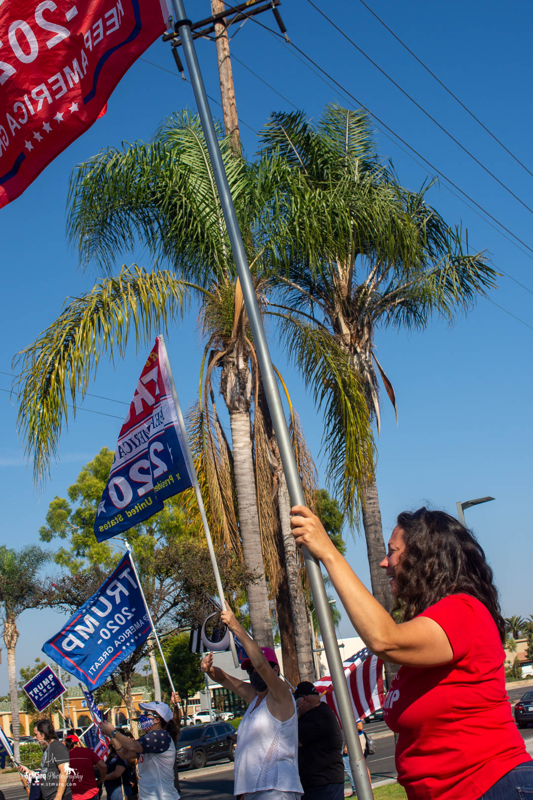 Caroline Hesse holds a pole with a Trump 2020 flag in support of the president at a Rally she and her boyfriend, Steven co-organized on Sunday, October 18, 2020 in La Habra, California. 
