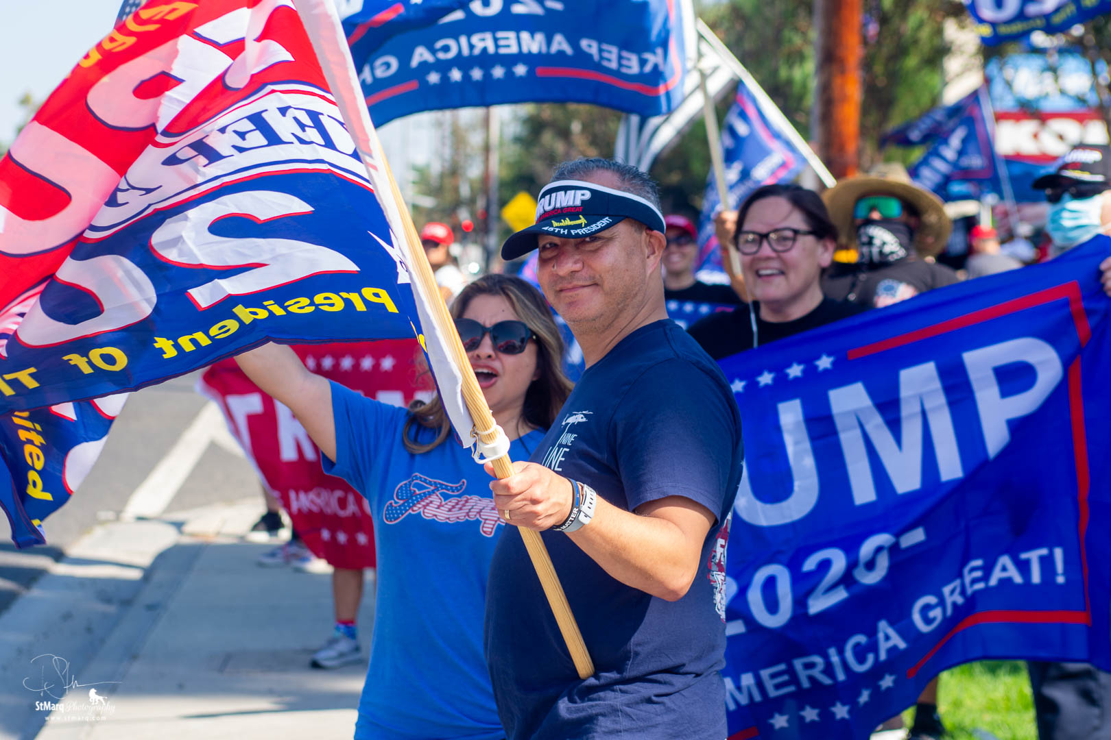 Bill Thomas, center, holding flag, and his wife, center, left, attend a Rally in support of President Trump on Sunday, October 18, 2020 in La Habra, CA.