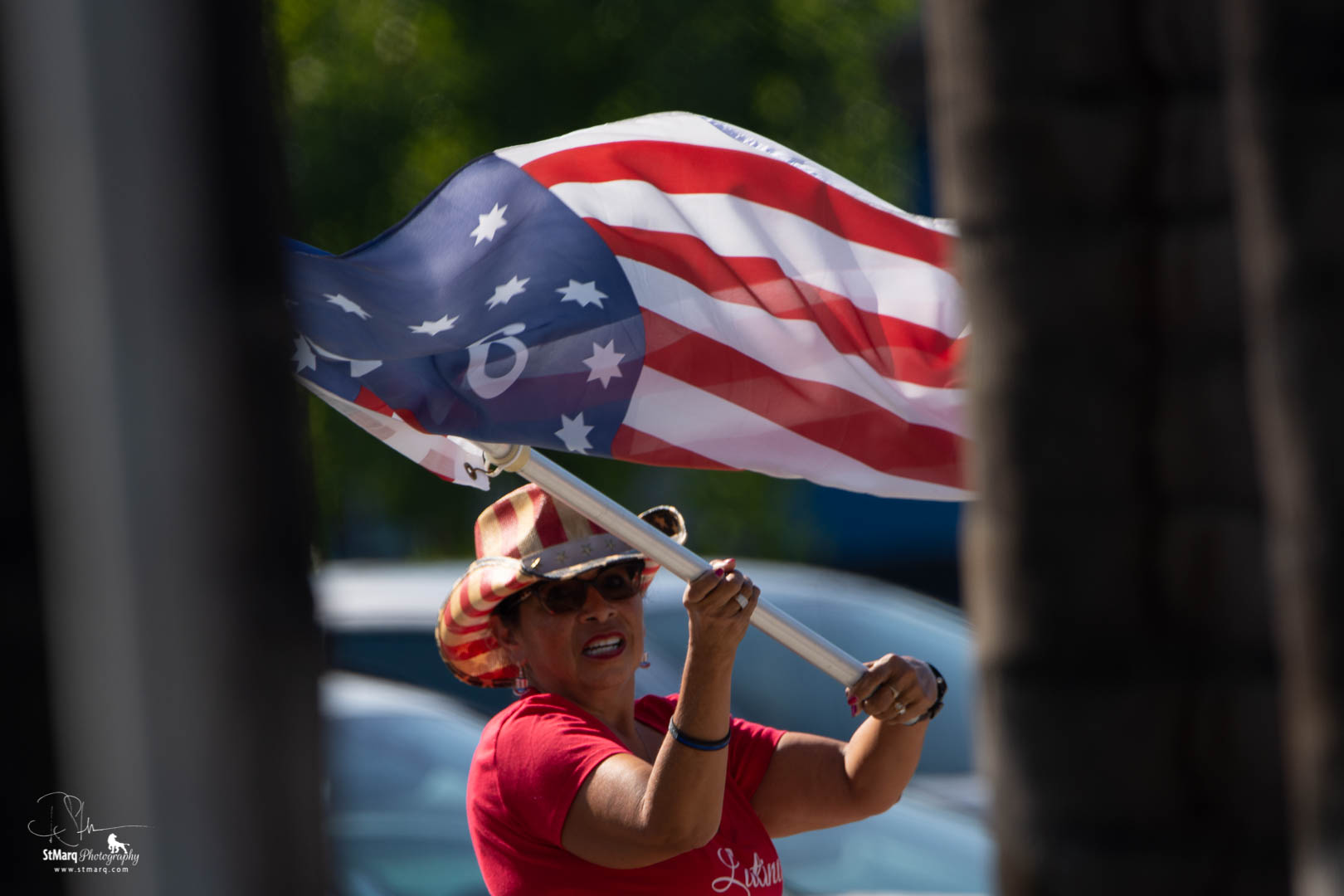 Marilyn Castillo waves the American flag at a Rally in support of President Trump.