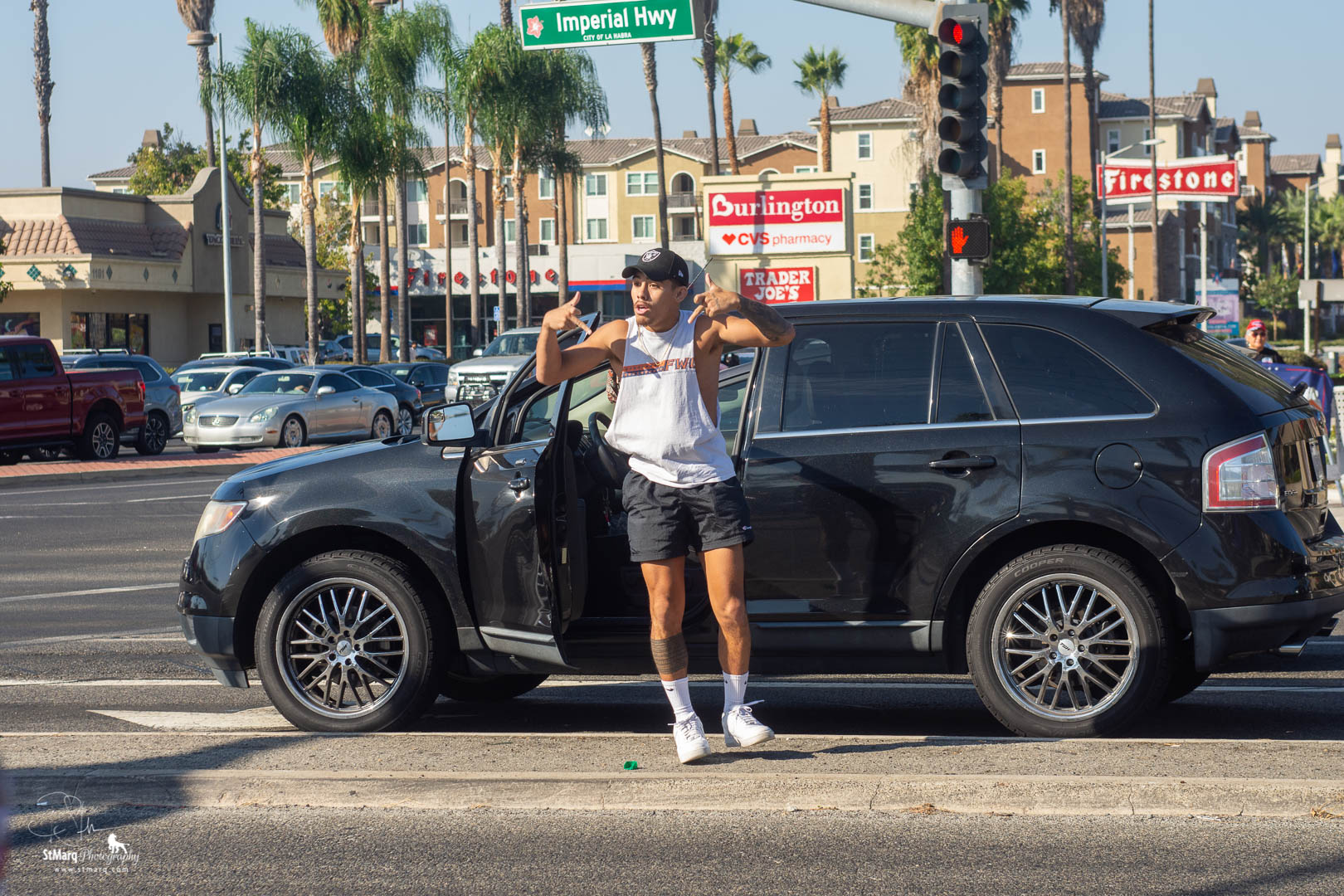 A counter Trump Rally protester danced outside his car with obscene hand gestures as he was waiting to make a left turn from Imperial Highway in front of Trump supporters.